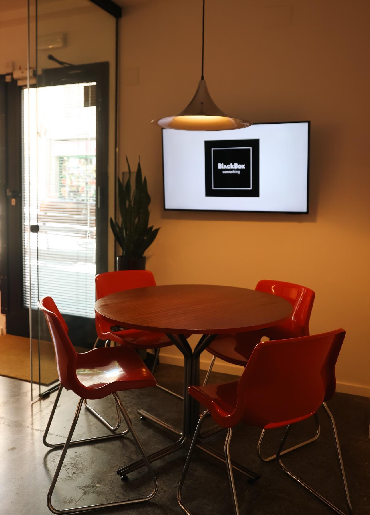 BlackBox Coworking meeting room with red chairs